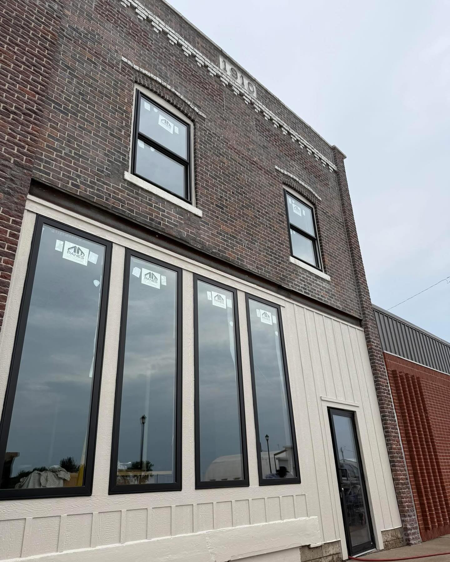 Panes windows with dark frames on a brick building in Paton, Iowa